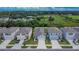Aerial view of a neighborhood showcasing well-maintained homes with green lawns and neatly paved driveways at 5547 Logan Cave Ave, Wimauma, FL 33598