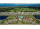 Aerial view of the community, including a pool, playground, and green spaces at Creek Preserve at 5547 Logan Cave Ave, Wimauma, FL 33598