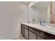 Modern bathroom with double sinks, vanity, and large mirror at 5547 Logan Cave Ave, Wimauma, FL 33598