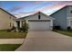 Charming single-Gathering home featuring a well-manicured lawn and a two-car garage at 5547 Logan Cave Ave, Wimauma, FL 33598