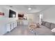 Open concept living room with tile floors, a ceiling fan, and a view into the kitchen at 5547 Logan Cave Ave, Wimauma, FL 33598