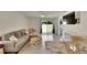 Cozy living room with tile flooring and sliding glass doors to the backyard at 5547 Logan Cave Ave, Wimauma, FL 33598