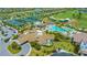 Aerial view of community amenities including tennis courts, clubhouse, pool, and surrounding golf course at 5609 Arnie Loop, Lakewood Ranch, FL 34211