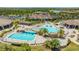 Aerial view of a community pool with waterfalls, lounge chairs, and clubhouse at 5609 Arnie Loop, Lakewood Ranch, FL 34211