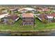 Stunning aerial view of the home and community, showcasing the pool, landscaping, and lake at 5609 Arnie Loop, Lakewood Ranch, FL 34211