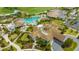 Aerial view of clubhouse and pool with water features, surrounded by tropical greenery at 5609 Arnie Loop, Lakewood Ranch, FL 34211