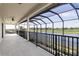 Screened-in balcony with ceiling fan overlooking the lake and golf course at 5609 Arnie Loop, Lakewood Ranch, FL 34211
