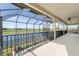Large screened-in balcony overlooking the lake and golf course with ceiling fan at 5609 Arnie Loop, Lakewood Ranch, FL 34211