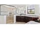 Bathroom featuring a glass shower, granite counters, and dark wood cabinets at 5609 Arnie Loop, Lakewood Ranch, FL 34211