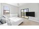 Neutral bedroom with plush carpeting and a sliding glass door to balcony with golf course views at 5609 Arnie Loop, Lakewood Ranch, FL 34211