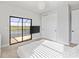 Bright bedroom features plush carpeting and a sliding glass door to balcony with golf course and lake views at 5609 Arnie Loop, Lakewood Ranch, FL 34211