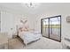Bright bedroom with large sliding glass doors to the balcony overlooking the golf course and lake at 5609 Arnie Loop, Lakewood Ranch, FL 34211