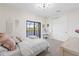 Bright bedroom with plush carpeting and a view of the lake from the sliding glass doors to the balcony at 5609 Arnie Loop, Lakewood Ranch, FL 34211