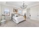 Comfortable main bedroom with decorative chandelier and large windows at 5609 Arnie Loop, Lakewood Ranch, FL 34211