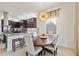 Open dining area features a unique chandelier and counter-height seating to the kitchen at 5609 Arnie Loop, Lakewood Ranch, FL 34211