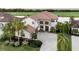Stunning two-story waterfront home with a tile roof, landscaped yard and a brick driveway at 5609 Arnie Loop, Lakewood Ranch, FL 34211