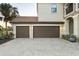 Spacious three-car garage with brick-paved driveway, perfect for car enthusiasts or extra storage at 5609 Arnie Loop, Lakewood Ranch, FL 34211