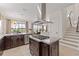 Bright kitchen with a center island and open to the backyard, with a view to the pool at 5609 Arnie Loop, Lakewood Ranch, FL 34211