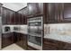 Kitchen features stainless steel appliances and beautiful dark wood cabinetry at 5609 Arnie Loop, Lakewood Ranch, FL 34211