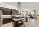 Modern kitchen features a large center island, stainless steel appliances, and open access to dining area at 5609 Arnie Loop, Lakewood Ranch, FL 34211