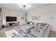 Bright living room featuring a sectional sofa, entertainment center, and tile floors at 5609 Arnie Loop, Lakewood Ranch, FL 34211