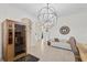 Elegant living room featuring a modern chandelier and access to staircase at 5609 Arnie Loop, Lakewood Ranch, FL 34211