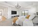 Light-filled main bedroom with a golf course view and decorative lighting at 5609 Arnie Loop, Lakewood Ranch, FL 34211