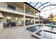 Covered patio with pool access, featuring an outdoor kitchen and comfortable seating at 5609 Arnie Loop, Lakewood Ranch, FL 34211