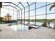 Luxurious screened-in pool area with spa and serene water views, ideal for outdoor enjoyment at 5609 Arnie Loop, Lakewood Ranch, FL 34211
