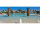 Resort style swimming pool with waterfalls and tropical landscaping, providing a tranquil escape at 5609 Arnie Loop, Lakewood Ranch, FL 34211
