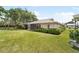 The backyard features well-maintained green grass, a screened-in patio and trimmed landscaping around the house at 5689 Evergreen Dr # 18, Sarasota, FL 34233