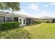 A screened-in back patio offers views of the beautifully maintained lawn at 5689 Evergreen Dr # 18, Sarasota, FL 34233