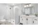 Bathroom features a glass shower door, marble walls, and a modern vanity at 5689 Evergreen Dr # 18, Sarasota, FL 34233