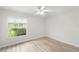 An empty bedroom with wood floors and a bright window view at 5689 Evergreen Dr # 18, Sarasota, FL 34233