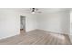 Spacious bedroom with new floors and fresh paint, with entry to en suite bathroom with white cabinets at 5689 Evergreen Dr # 18, Sarasota, FL 34233