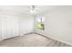 A bright bedroom features new floors, a ceiling fan, and double closets at 5689 Evergreen Dr # 18, Sarasota, FL 34233
