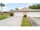 View of the home's driveway, complemented by lush green lawns at 5689 Evergreen Dr # 18, Sarasota, FL 34233