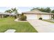 Charming home featuring an attached garage and a well-manicured lawn at 5689 Evergreen Dr # 18, Sarasota, FL 34233