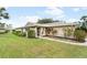 Charming single-story home featuring a well-maintained lawn and landscaping at 5689 Evergreen Dr # 18, Sarasota, FL 34233