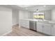 Open kitchen featuring white cabinetry, quartz countertops, and stainless appliances at 5689 Evergreen Dr # 18, Sarasota, FL 34233