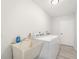 Bright laundry room with a utility sink and full size washer and dryer at 5689 Evergreen Dr # 18, Sarasota, FL 34233