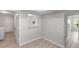 Neutral living space with gray vinyl floors, white walls, and decorative pass-through to the kitchen at 5689 Evergreen Dr # 18, Sarasota, FL 34233