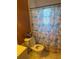 Bathroom featuring a toilet and shower with coral-themed curtain at 6324 Case Ave, Bradenton, FL 34207