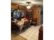 Dining room with a wood-paneled accent wall and bright tile floors at 6324 Case Ave, Bradenton, FL 34207