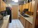 Functional kitchen with white tiled floor, contrasting cabinets, and essential appliances at 6324 Case Ave, Bradenton, FL 34207