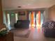 Bright living room featuring a large window, carpet, and comfortable seating arrangement at 6324 Case Ave, Bradenton, FL 34207