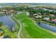 Panoramic aerial view featuring a golf course community with waterfront homes and lush landscaping at 643 Misty Pond Ct, Bradenton, FL 34212