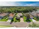 Aerial view of homes near a lake are surrounded by lush landscaping at 643 Misty Pond Ct, Bradenton, FL 34212
