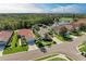 Aerial view of home with lush landscaping and a brick paver driveway surrounded by a lake and golf course at 643 Misty Pond Ct, Bradenton, FL 34212