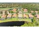 Stunning aerial view of the home surrounded by lush greenery and a peaceful pond at 643 Misty Pond Ct, Bradenton, FL 34212